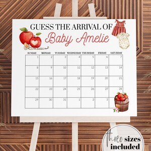 May include: A white baby shower calendar on an easel with the text "GUESS THE ARRIVAL OF Baby Amelie." The calendar includes illustrations of apples, baby clothes, and a wooden barrel of apples. Three sizes are included: 16x20", 18x24" & 24x36".