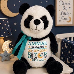 May include: A plush panda toy with black and white fur, featuring a teal ribbon around its neck. The white belly is embroidered with the name AMMAR VASEEM, the date 09.27.2025, the time 5:11 AM, and birth stats of 5 pounds 7 ounces and 18 inches.