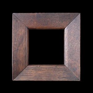 May include: Square wooden picture frame with a dark brown finish. The frame has a simple, classic design with a visible wood grain texture. The frame is set against a black background.