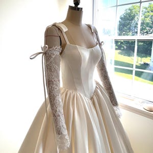 Lace Sleeves Basque Waist Ball Gown Wedding Dress With Cat Eye Neckline