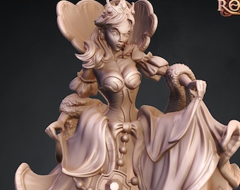 May include: A 3D printed miniature of a woman wearing a crown and a flowing gown. The miniature is painted in a light brown color and is standing on a circular base. The base is decorated with a pattern of geometric shapes. The miniature is labeled "Maiden 485".