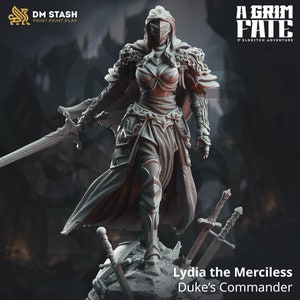 May include: A gray 3D printed miniature of a female warrior in full armor, holding a sword. She is standing on a rocky base with two swords lying on the ground. The text "Lydia the Merciless Duke's Commander" is below the figure.