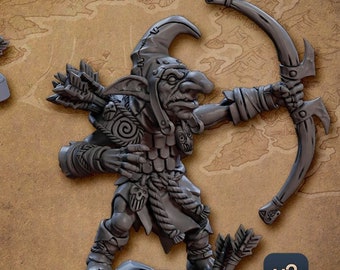 May include: Two 3D printed miniature figures of goblins. The goblin on the left is holding a spear and shield. The goblin on the right is holding a bow and arrow. Both goblins are wearing armor and have a green skin tone. The text "ALTERNATIVE VERSION! BALLJOINT WEAPONS!" is below the goblin on the left. The text "v1" is below the text. The text "v2" is below the goblin on the right.