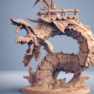 May include: A detailed, beige-colored fantasy miniature depicting a creature with a large, open-mouthed head and a segmented body. A figure stands atop a wooden structure on the creature's back. The text "*mini not included" and "v1" are visible.