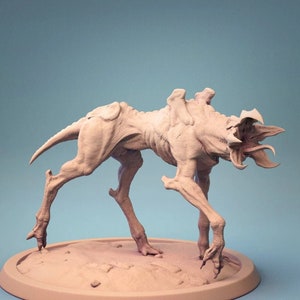 May include: A detailed, beige-colored, 3D printed model of a monstrous creature with a large, open mouth and sharp teeth. The creature is standing on a circular base.