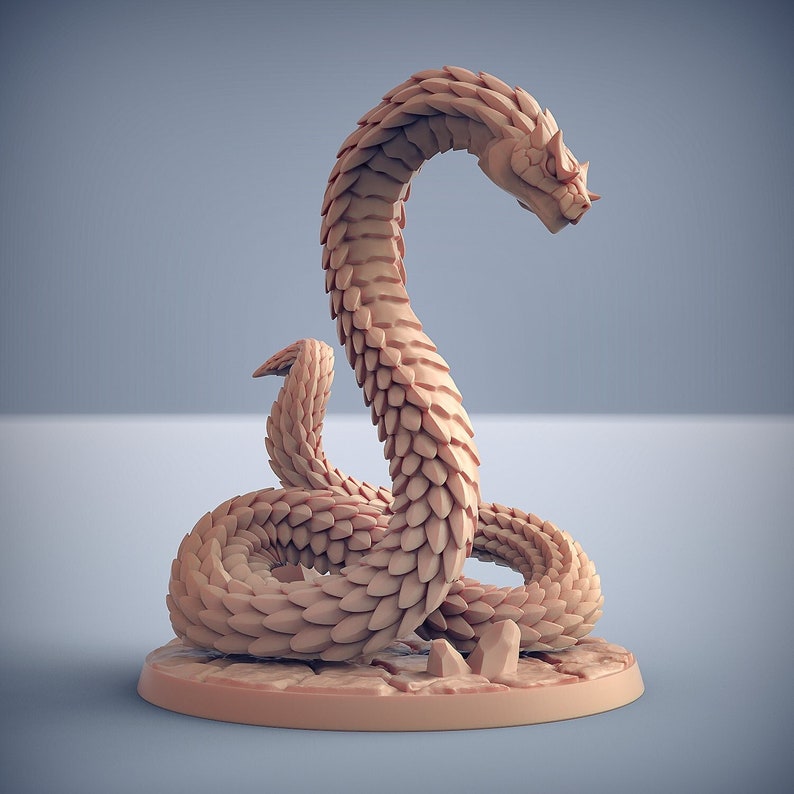 May include: A beige, stylized snake figurine with a textured, scale-like pattern. The snake is coiled on a circular base with a rough, stone-like texture. The snake's head is raised, and the overall design suggests a fantasy or mythological theme.