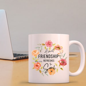 May include: White ceramic coffee mug with a floral design and the text "A sweet FRIENDSHIP REFRESHES the Soul. Prov. 27:9"