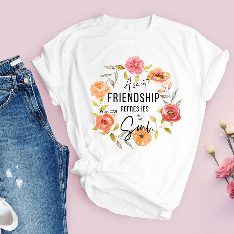 May include: White t-shirt with a floral wreath design and the text "A sweet friendship refreshes the soul."  Prov. 27:9
