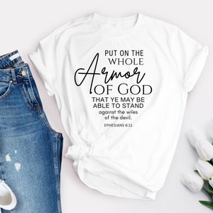 May include: White t-shirt with black text that reads "Put on the whole Armor of God that ye may be able to stand against the wiles of the devil. Ephesians 6:11"