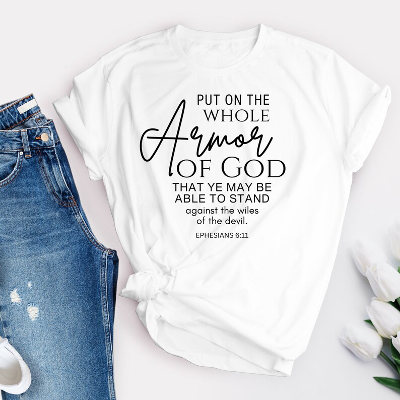 May include: White t-shirt with black text that reads "Put on the whole Armor of God that ye may be able to stand against the wiles of the devil. Ephesians 6:11"