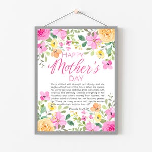 May include: A framed print with a floral border featuring pink, yellow, and orange flowers. The text "HAPPY Mother's DAY" is in pink script. The print includes a Bible verse about a virtuous woman.