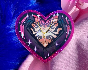 May include: A heart-shaped sticker with a pink glitter border. The sticker features a stylized illustration of a person's chest and a gold necklace. The illustration has a black jacket and a peach-colored chest. White star accents are scattered around the image.