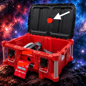 May include: A red and black modular storage box with an open lid featuring a circular red emblem. The box has metal corner reinforcements, black locking latches, and a red informational tag attached to the front with the text MOST VERSATILE.
