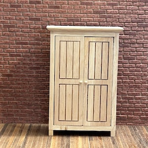 Wardrobe 2 doors cabinet. 1/12 Scale in unpainted wood. 2 large functional plant style doors. Interior 2 shelves and 1 clothes pole. 14303.