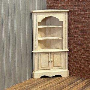 Old style corner Cupboard. 1/12 Scale in unpainted wood. Scrolled top, 2 scrolled shelves, 2 functional boxed doors and scrolled base.195000