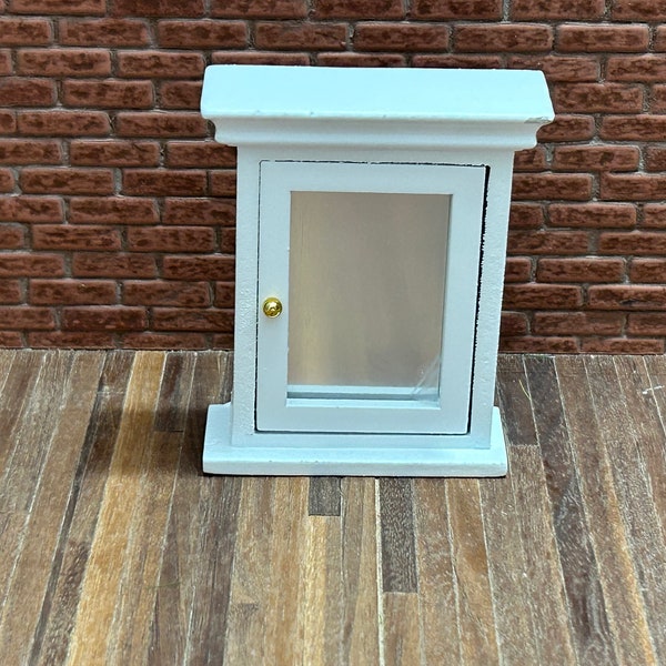 Beautiful little white bathroom medicine cabinet with functional shelf door and mirror. 12217