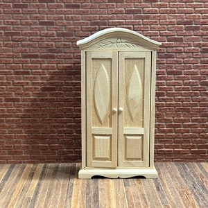 Wardrobe 2 doors cabinet. 1/12 Scale in unpainted wood. Curved top, 2 box doors, carved top, scalloped base, 2 interior shelves. 14902