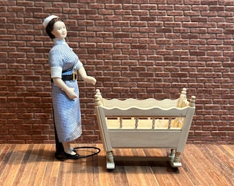 DIY Antique-style cradle made of unpainted wood, with a fretted top, turned legs, and a wooden base.  1:12 scale for dollhouses. 20503.