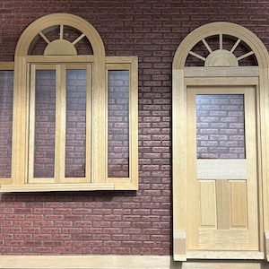 May include: Two arched wooden doors with glass panels and decorative transoms. The doors are set in a brick wall.