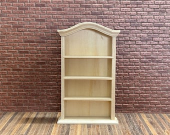 Vintage style open bookcase. 1/12 Scale in unpainted wood. Beautiful curved and molded top, 3 shelves and molded base. 13004.