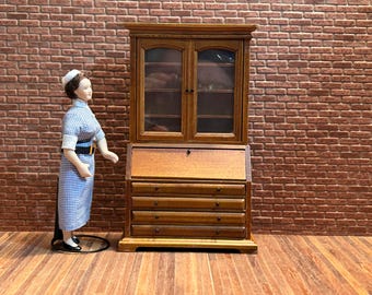 Wooden writing desk with two glass doors, one panel, and four large, functional drawers. 1:12 scale for dollhouses. 22406.