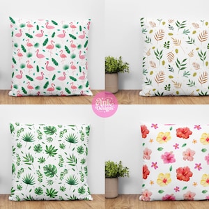 May include: Four decorative throw pillows with white backgrounds. One pillow features pink flamingos and green leaves. Another has green and brown leaves. The third has green tropical leaves, and the last has red, pink, and yellow flowers.