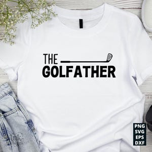 May include: White t-shirt with the text "THE GOLFFATHER" in bold black letters. A golf club graphic replaces the "F" in "GOLFFATHER". The shirt is a casual style, suitable for golf enthusiasts.