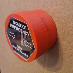 May include: Red break glass emergency alarm with a black hexagonal label that reads "IN CASE OF EMERGENCY 10MM BREAK GLASS" with arrows pointing to the left and right.