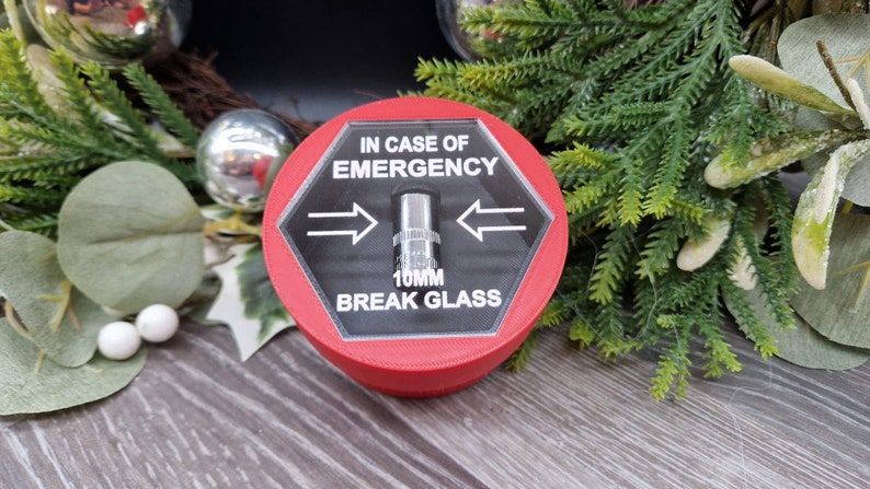 May include: Red hexagonal break glass emergency box with a clear plastic cover and a silver metal striker. The box has the text "IN CASE OF EMERGENCY" and "10MM BREAK GLASS" printed on it.