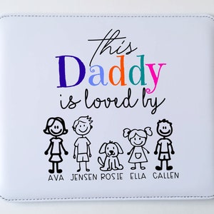 May include: White square mousepad with the text "this Daddy is loved by" in a colorful font. Below the text are stick figure illustrations of a family and a dog, with names below each figure.