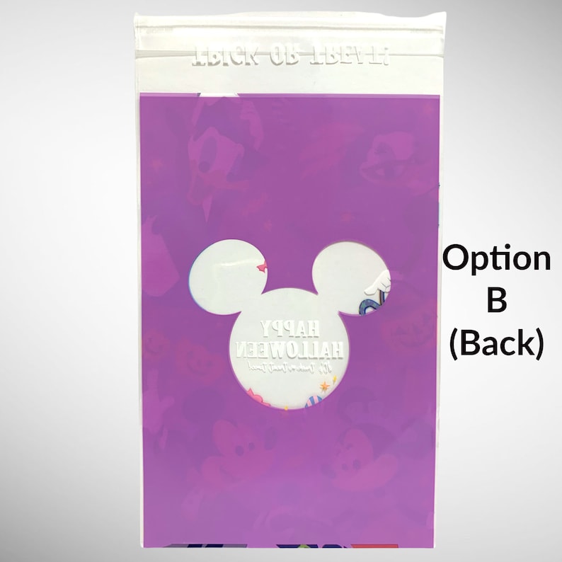 May include: Purple plastic bag with a Mickey Mouse head cutout. The cutout reveals a white background with the text "Happy Halloween" in white lettering. The bag has a zipper closure at the top.