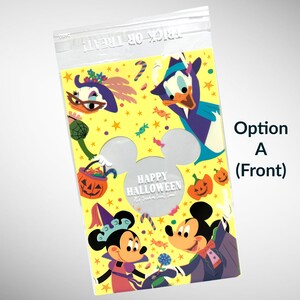 May include: A yellow plastic treat bag with a Mickey Mouse head cutout. The bag features a Halloween theme with Mickey Mouse, Minnie Mouse, Donald Duck, and the text "Happy Halloween Trick or Treat Time!"