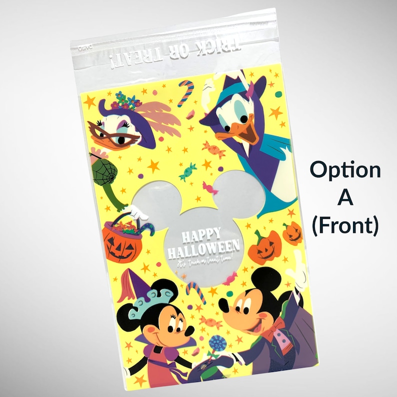 May include: A yellow plastic treat bag with a Mickey Mouse head cutout. The bag features a Halloween theme with Mickey Mouse, Minnie Mouse, Donald Duck, and the text "Happy Halloween Trick or Treat Time!"