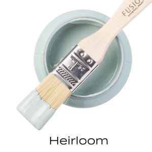 May include: A small jar of light blue paint with a paintbrush dipped in the paint. The jar is labelled "Fusion Mineral Paint" and the paint colour is "Heirloom".