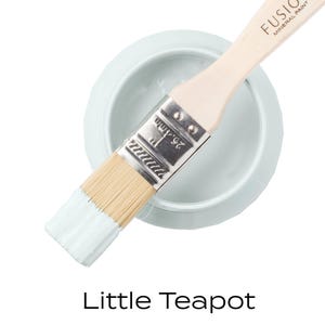 May include: A small jar of light blue paint with a paintbrush on top. The paint is labelled "Fusion Mineral Paint" and the colour is "Little Teapot".
