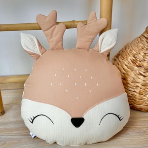 Handmade deer nursery pillow with woodland animal design in neutral colors for baby room decor