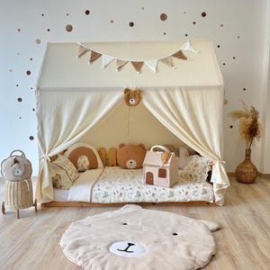 Muslin canopy draped over toddler floor bed in cozy kids room