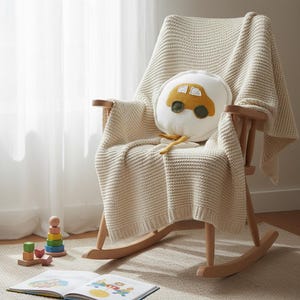Car decorative pillow styled in cozy nursery play area with soft furnishings