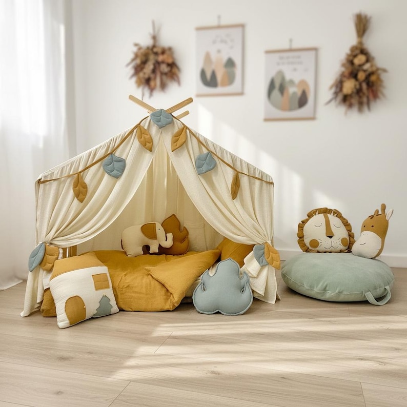 Neutral muslin canopy hanging above floor mattress cozy kids play corner.