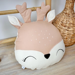 Handmade deer nursery pillow with woodland animal design in neutral colors for baby room decor