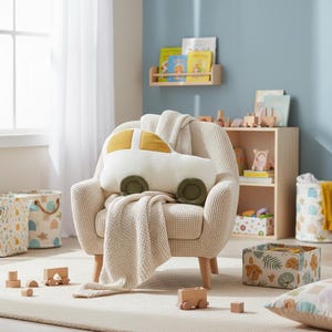 Car decorative pillow styled in cozy nursery play area with soft furnishings