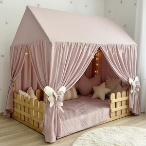 Muslin fabric canopy over reading pillows