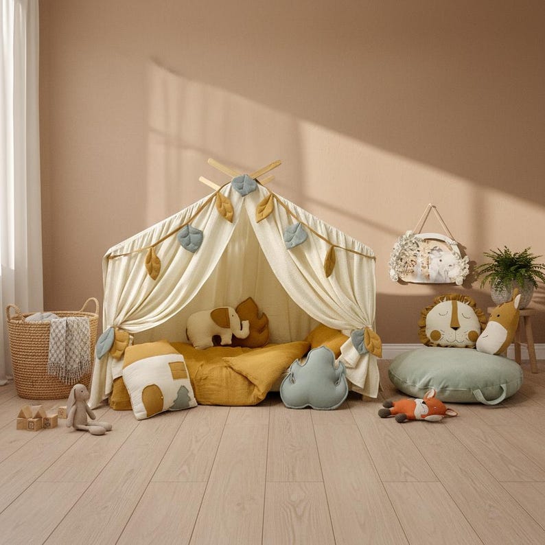 Handmade cotton muslin bed canopy draped over a kids’ Montessori house bed for playroom and reading nook decor.