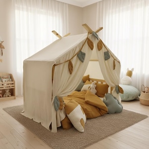 Neutral muslin canopy hanging above floor mattress cozy kids play corner.