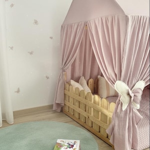 Muslin fabric canopy over reading pillows