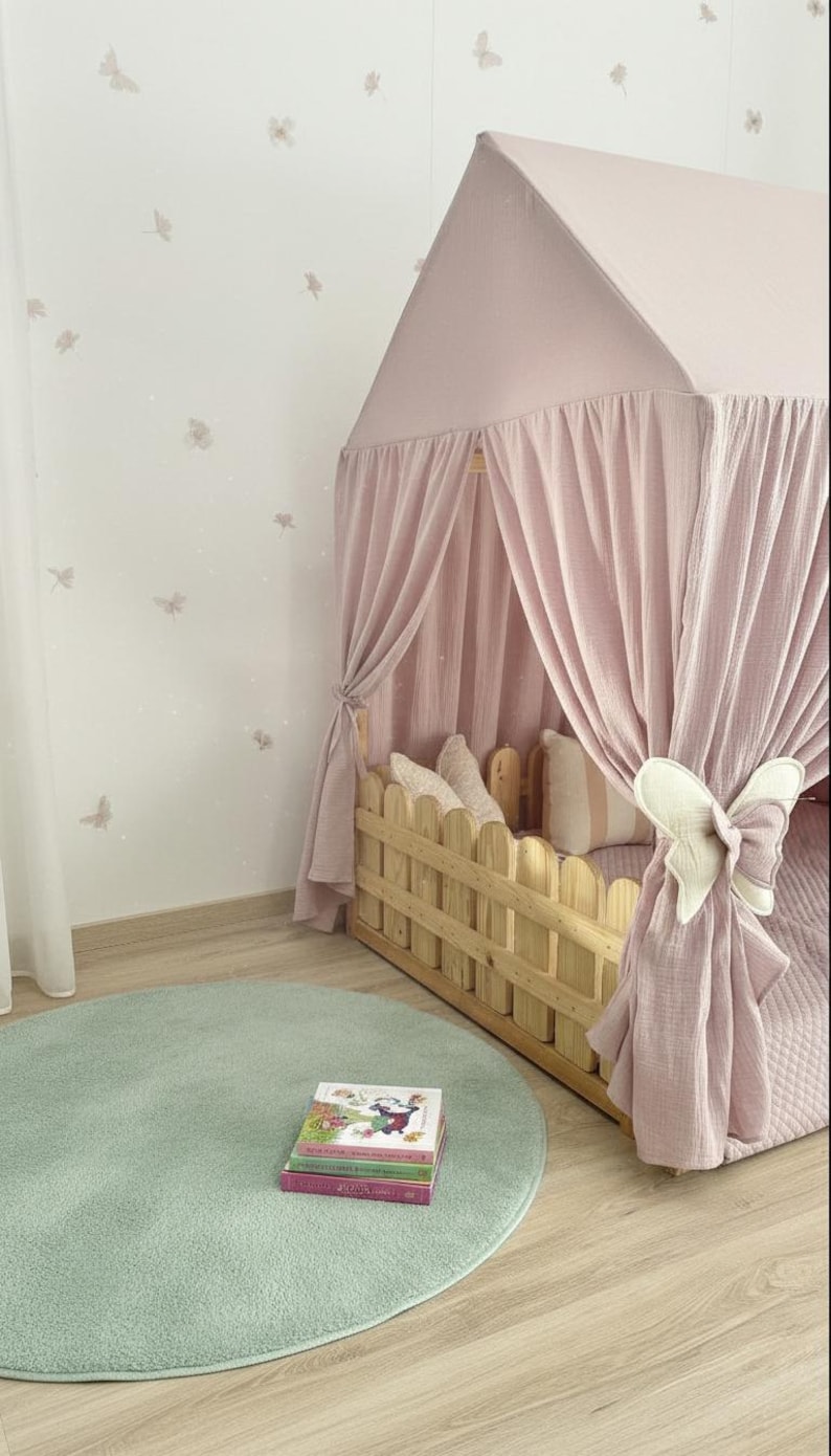 Muslin fabric canopy over reading pillows