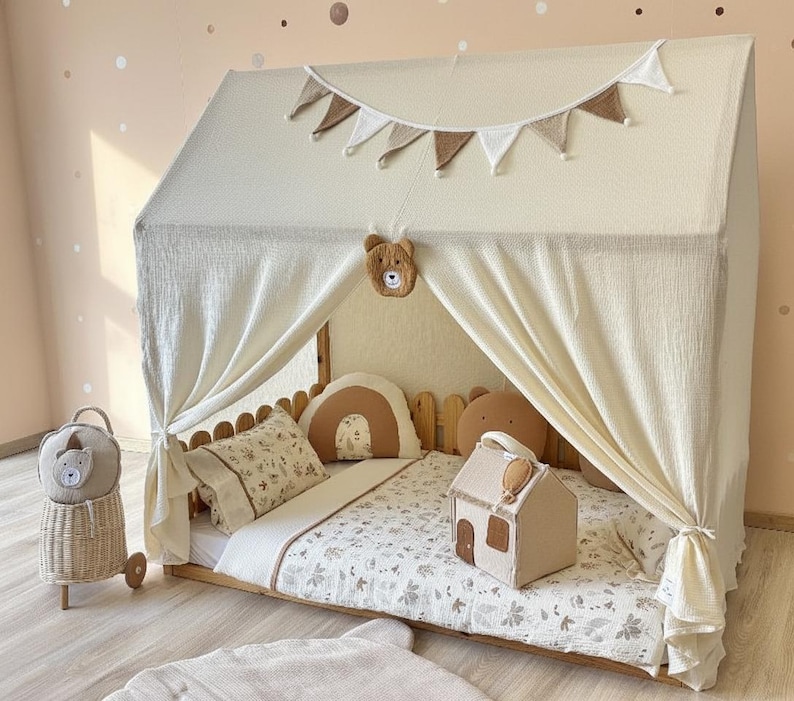 Neutral nursery canopy styling with pillows and warm lighting