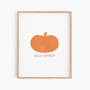 Może przedstawiać: Wydruk w ramie z prostą ilustracją pomarańczowej dyni i tekstem "HELLO PUMPKIN" w kolorze białym.