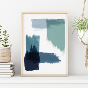 May include: Abstract art print with blue and green brushstrokes in a wooden frame. The print is hanging on a white wall with a potted plant on a shelf below.