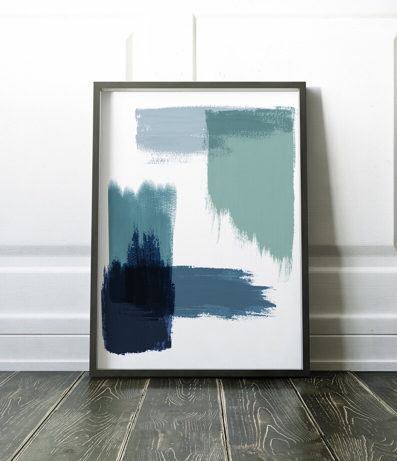 May include: Abstract art print in a black frame with blue and green brushstrokes on a white background.